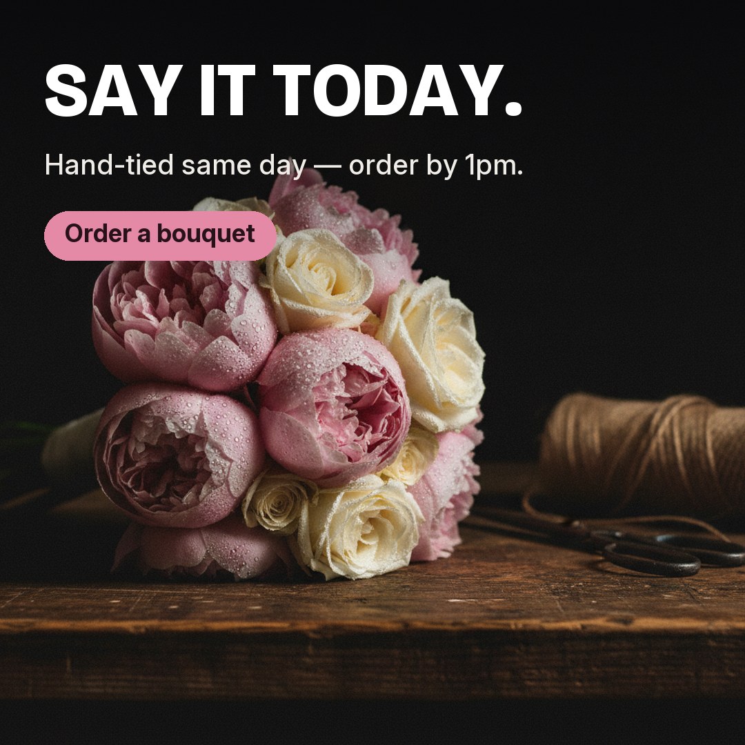 Advert: hand-tied bouquet in dramatic light — Say it today, hand-tied same day